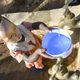 Projekt Regenwasserauffang an einem Felsen und Speicherung in Tanks zur Nutzung in Dürreperioden, Agnes Irima, 44 Jahre, und Enkelin an Wasserstelle Projektpartner ADS-MKE - Anglican Develoment Service - Mount Kenya EastAnglican Develoment Service Mount Kenya East