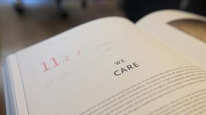 Eine aufgeschlagene Broschüre; auf der Seite steht "We care". 