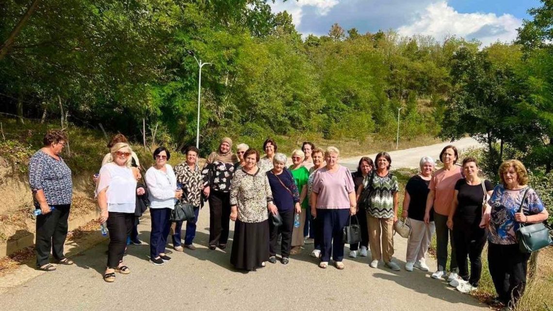 Eine große Gruppe älterer Frauen auf einer Landstraße.